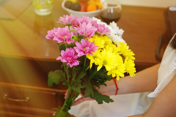 Girl holds a bouquet of beautiful spring flowers in the hotel