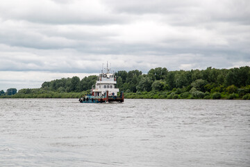 old tug goes on the river