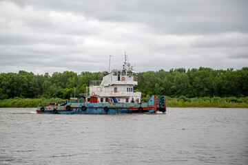 old tug goes on the river