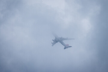 airplane in dust and dark clouds