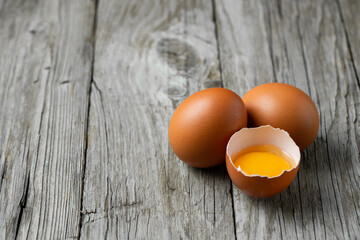 Close-up view of raw eggs isolated on Brown background.