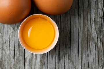 Close-up view of raw eggs in egg Sack on white wooden background