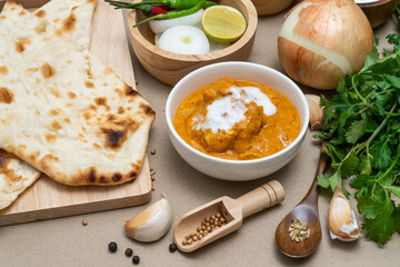 Assorted indian food, biryani rice, butter chicken, tandoori, bean curry and naan bread