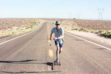 Fototapeta premium Man skateboarding on an open road