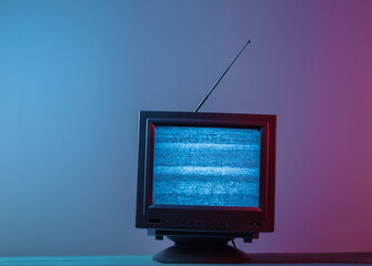 Mini Retro tv antenna receiver. Old fashioned TV set. Pink blue gradient neon light. Television...