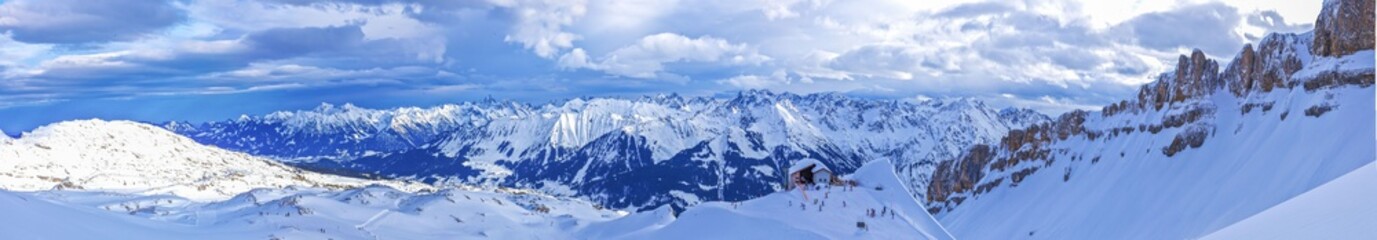 Fototapeta na wymiar Panoramic picture of Ifen ski lift mountain station at daytime with blue skies in winter during skiing season