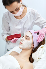 Naklejka premium female face while procedure ultrasound cleansing, facial peeling. ultrasonic treatment for skin rejuvenation