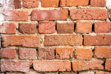 Obraz premium Orange brick wall that is eroded