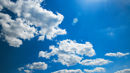 White shaggy clouds on a blue sky. There is a clean place for the inscription.  Use for the background.
