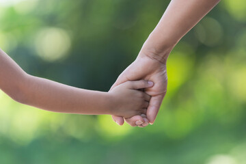 hand hold mom Concept
Love the giver
Of mothers with children On blurred background nature 