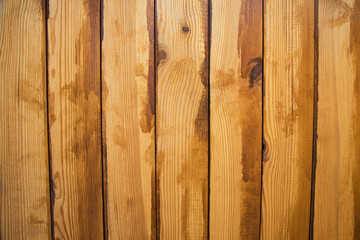 Wooden board in stains of varnish. There are knots on wooden boards.