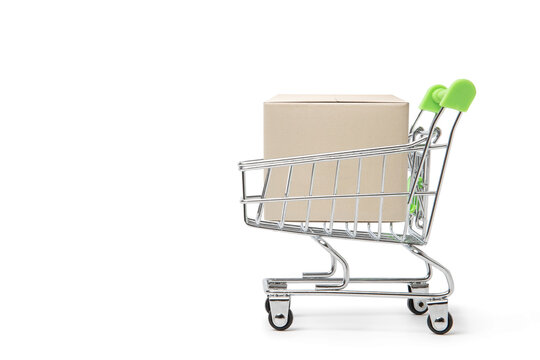Online shopping and delivery service concept. Paper boxes in a shopping cart on Shopping cart, this image implies online shopping that customer order things from retailer sites via the internet.