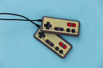 Video game Gamepads. Gaming concept. Top view two retro joysticks on blue background. Flat lay © splitov27
