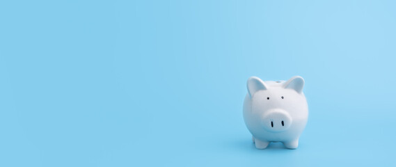 Piggy bank with copy space on blue background,front view