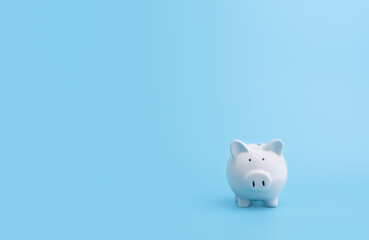 Piggy bank with copy space on blue background,front view