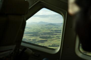 Aerial view on plane window at green fields from Addis Ababa, aircraft aviation business in Africa