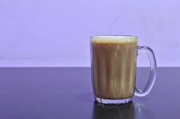 Teh tarik or pulled tea is a famous sweet milk tea in Malaysia. Bubble is floating on the surface of teh tarik.