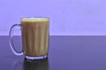 Teh tarik or pulled tea is a famous sweet milk tea in Malaysia. Bubble is floating on the surface of teh tarik.