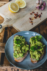 Healthy avocado toast on the wooden cutting board 