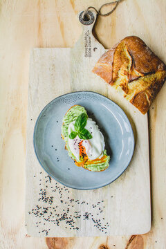 Poached egg on the slice of bread   with basilium 