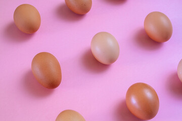 Eggs in kitchen top view pink background - natural food pattern