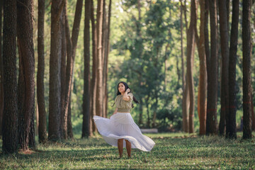 women asian girl walking in the natural park pine forest alone nature people concept.