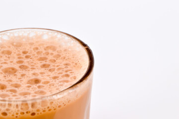 Teh tarik or pulled tea is a famous sweet milk tea in Malaysia. Bubble is floating on the surface of teh tarik.