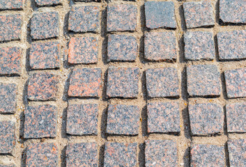 stone pavement of multicolored granite close up