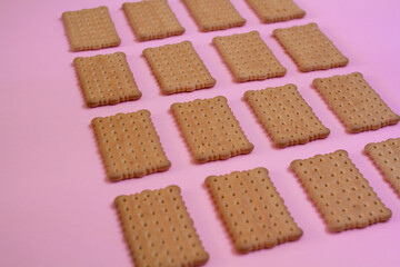 Biscuits in a pink background food pattern - diet, breakfast concept