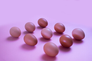 Eggs in kitchen top view pink background - natural food pattern