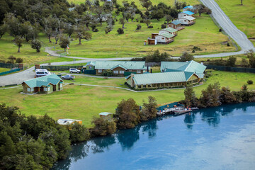 Fototapeta na wymiar Patagonia, Chile - March 03, 2020: Houses and other Hotel Buildings on the Lake Coast in the Torres Del Paine National Park