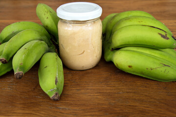 Nutrition concept - Green Banana Biomass in glass jar, good source of fiber, vitamins and minerals, and contains a starch that may help control blood sugar, manage weight and lower blood cholesterol.