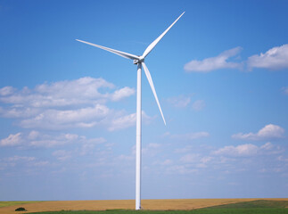 Wind turbine under blue sky