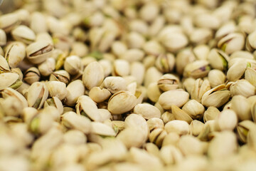 Bunch of white pistachios in supermarket. Healthful uncooked nuts in grocery. Superfood, healthy eating, assortment.