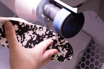 Sanding a shoe insole with a sander