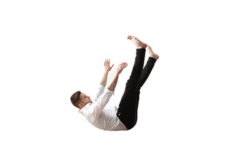 Mid-air beauty cought in moment. Full length shot of young man hovering in air and keeping eyes...