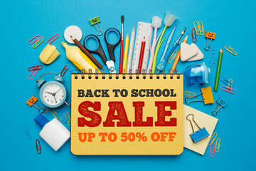 Back to school - sale, stationery set on blue background. Shop promotion and advertising. 50%...
