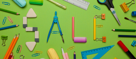 Back to school - sale, stationery set on green background. Shop promotion and advertising. 50% discount. Retail flyer.