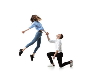 Mid-air beauty cought in moment. Full length shot of attractive young woman and man hovering in air and keeping eyes closed. Levitating in free falling, lack of gravity. Freedom, emotions, artwork - obrazy, fototapety, plakaty