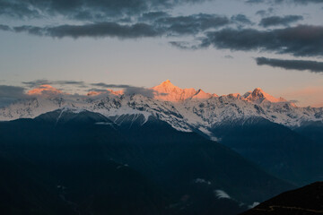 Sunrise at Snow Mountain Meili, a sacred mountain in Tibet, China.