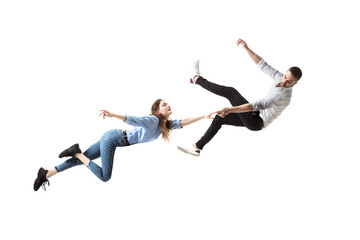 Fototapeta na wymiar Mid-air beauty cought in moment. Full length shot of attractive young woman and man hovering in air and keeping eyes closed. Levitating in free falling, lack of gravity. Freedom, emotions, artwork
