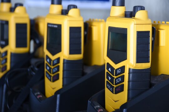 Yellow portable GMDSS VHF radio using on the ship during emergency safety or security situation, such as abandon ship or fire. Compulsory equipment of the vessel.