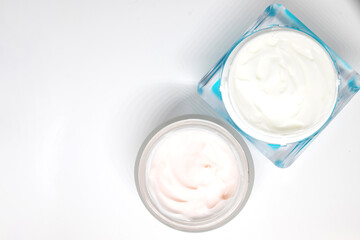 cosmetic cream in container isolated on white background. Jar with moisturizing body cream. Skin care cosmetic concept. Minimal flat lay style composition, top view