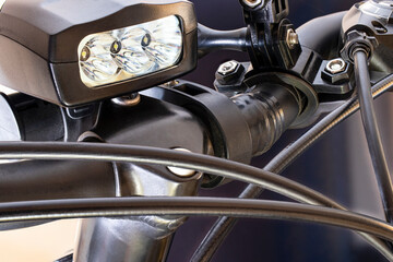 Handlebar and headlight on a bicycle. Gear shift. Sports bike design element. Spot and technology. Close-up. Leisure