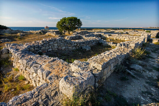 Tauric Chersonesus. Ruins of an ancient city on the beach at sunset. Ruins, antique columns. 
