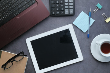 digital tablet, laptop and office suppliers on desk 