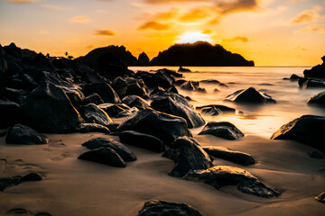 Beautiful Long Exposure in a Sunset view on the rocks formation at Cachorro Beach, Fernando de...