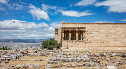 Fototapeta na wymiar Athens, Greece. Erechtheion with Caryatid Porch on Acropolis hill, blue sky background