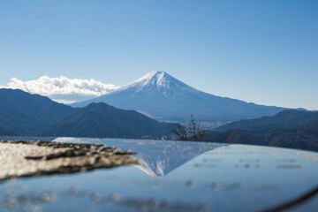 The reflection of Mt.Fuji in guidepost from Mt.Takagawa, Japan
