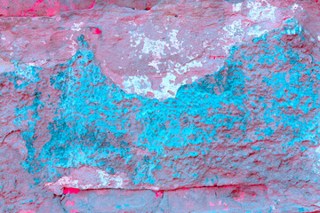Old concrete wall covered with colorful paint.